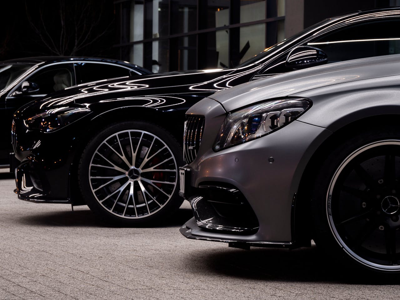 creative-03 Close-up of luxury Mercedes cars parked in Wrocław, showcasing sleek design and shiny rims.